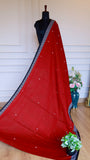 Full-length view of a Red Dhonekhali Handloom Cotton Saree on a mannequin showing the elegant drape and white thread work.