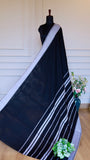 Full-length view of the Dhonekhali saree draped on a mannequin, highlighting the striped white pallu and elegant black body.