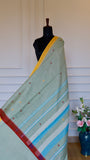 Full-length view of a Sage Green Dhonekhali Handloom Cotton Saree draped on a mannequin, showcasing the elegant fall and yellow border.