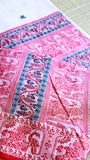 Detailed view of the expansive saree pallu featuring horizontal rows of traditional handwoven red and black motifs on a premium cotton base.
