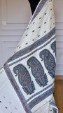 Close-up view of the pallu on an off-white Baluchari Cotton Saree showcasing three large black and crimson paisley motifs.