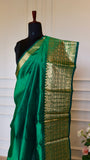Close-up shot of the rich gold zari pallu featuring floral motifs on the Emerald Green Mangalagiri saree.