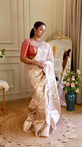 Full-length view of model draping the lightweight ivory Munga Contrast Banarasi Saree next to a gold ornate mirror.