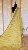 Full display of sunny yellow Maheshwari silk saree with black block printed bootis on mannequin