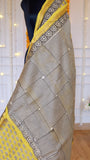 Close-up shot of criss-cross geometric handblock striped pattern on cream and yellow Maheshwari silk saree pallu