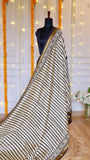 Full drape display of off-white and black striped Maheshwari silk saree on a mannequin.