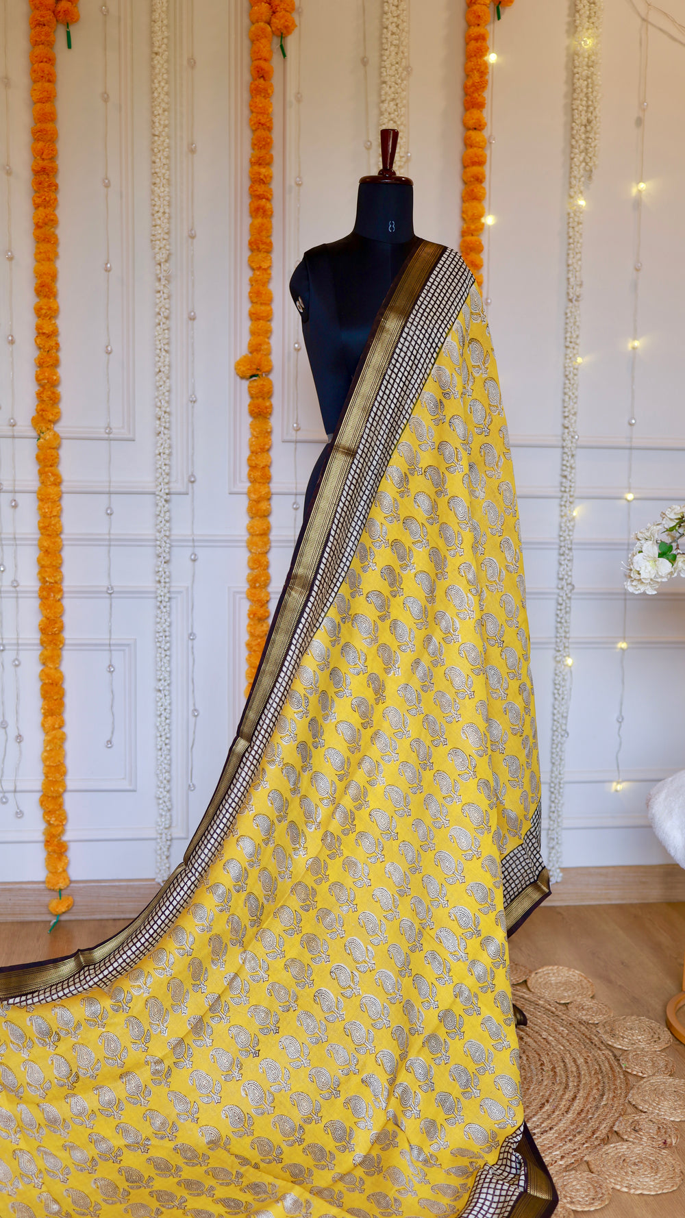 Full drape view of Yellow Maheshwari Silk Saree with paisley motifs and black grid border styled on a mannequin.