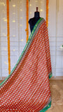 Full length view of Rust Red Maheshwari Silk Saree draped elegantly with all-over traditional block prints.