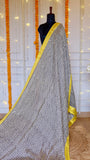 Full pleat display of the black and white zig-zag print Maheshwari Silk Saree highlighted by its yellow selvedge.