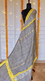 Pallu detail of the off-white Maheshwari Silk Saree showing black grid checks and thin gold zari woven stripes.