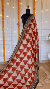 Rust orange and beige geometric triangle printed Maheshwari silk saree draped on mannequin
