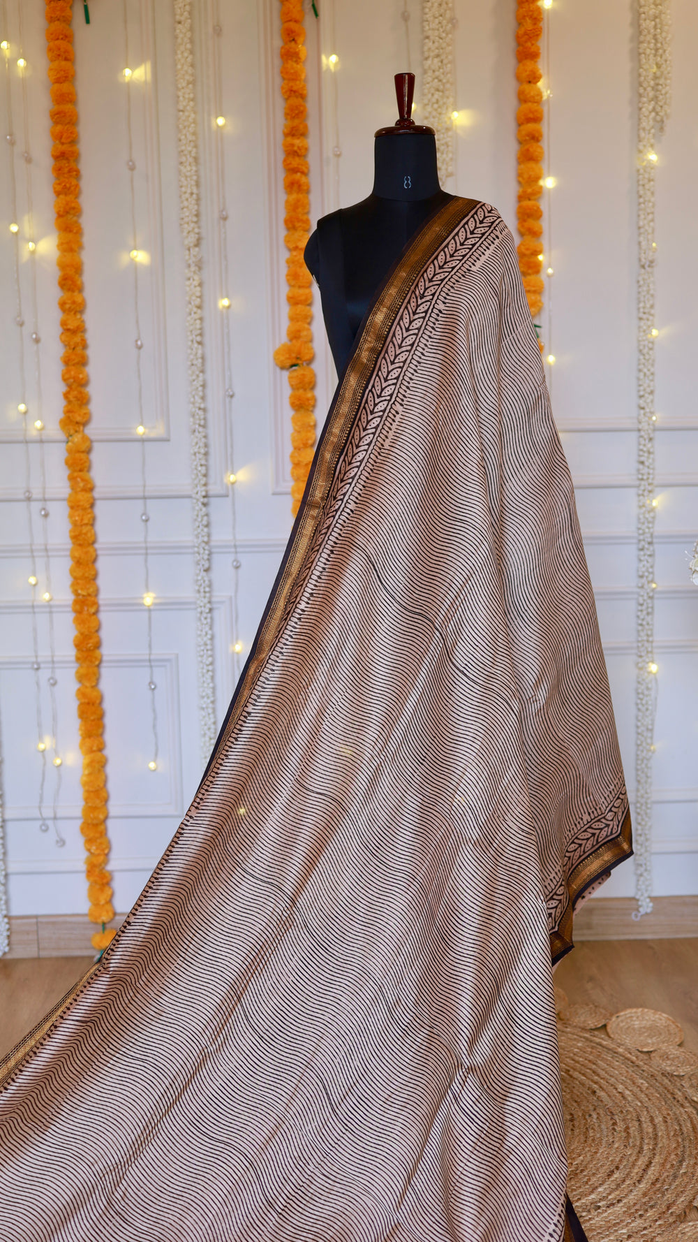 Full length view of beige hand block printed Maheshwari silk saree with fine wave lines and gold zari border