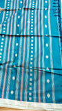 Detailed view of handwoven Peacock Teal Khadi Cotton Saree body displaying fine vertical stripes, woven star motifs, and dark blue tassels.