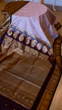 Wide perspective display of lilac semi Gadwal silk saree draped elegantly with rich golden zari pallu and dark purple border.