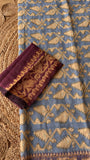 Close-up of powder blue Kardana Jamdani saree fabric paired with contrasting deep plum purple unstitched blouse piece.