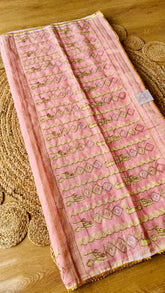 Full view of blush pink handwoven kardana jamdani saree laid flat showing gold zari pallu embellishments and lace edging.