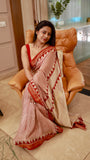 Model wearing a Titafu Maheshwari Silk Saree with red horizontal stripes, a cream base, and traditional triangle borders on a staircase.