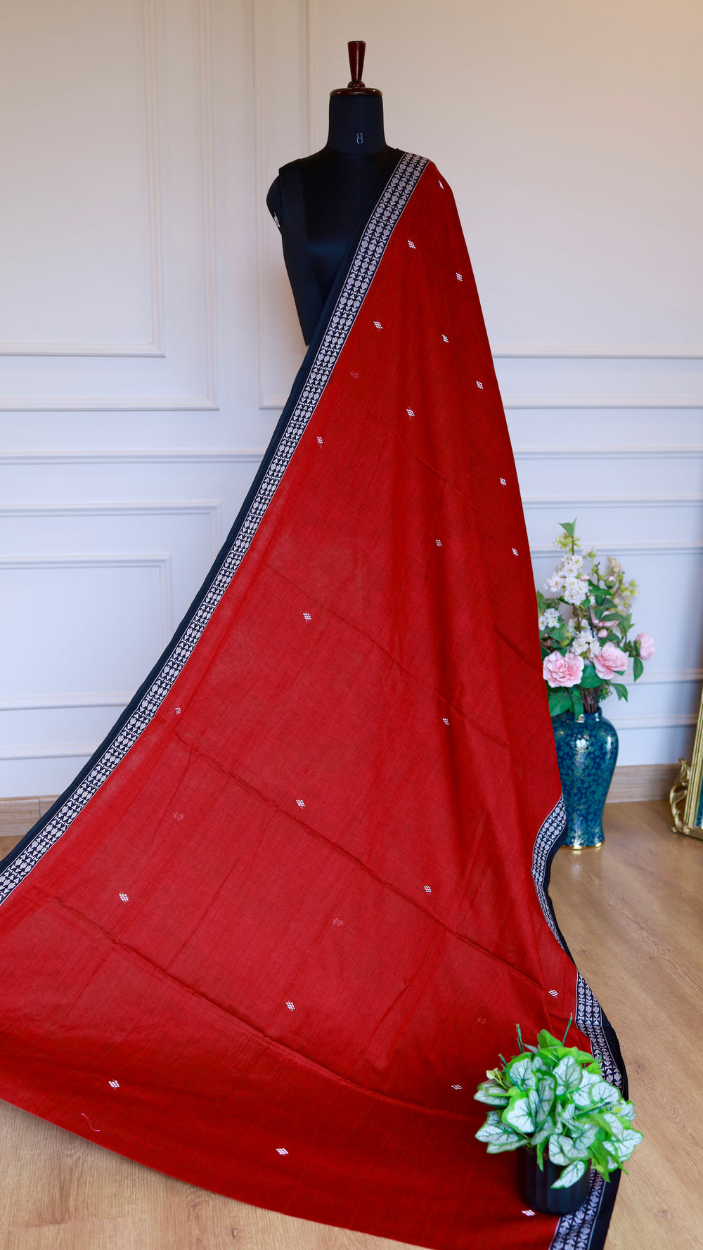 Full-length view of a Red Dhonekhali Handloom Cotton Saree on a mannequin showing the elegant drape and white thread work.
