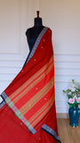 Detailed view of the Dhonekhali saree pallu featuring ochre and gold horizontal stripes against the red handloom base.