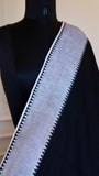Close-up detail of the white border with a distinct black triangle pattern against the mannequin's shoulder.