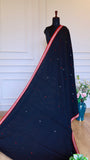 Full drape of Black Dhonekhali Saree on a mannequin showcasing the elegant fall and red temple border design