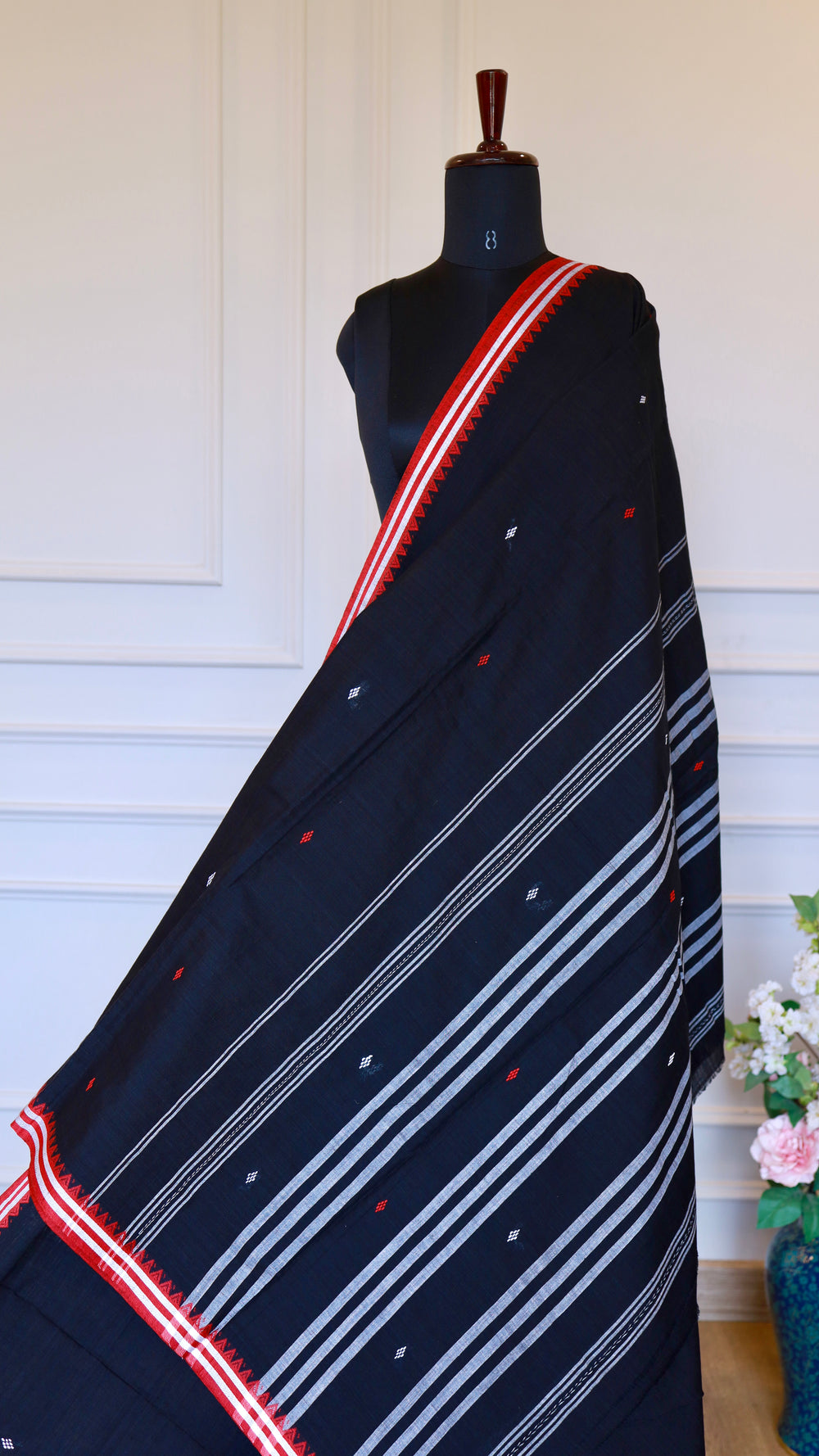 The Pallu of the Black Dhonekhali Saree featuring traditional horizontal white stripes and dense thread work patterns