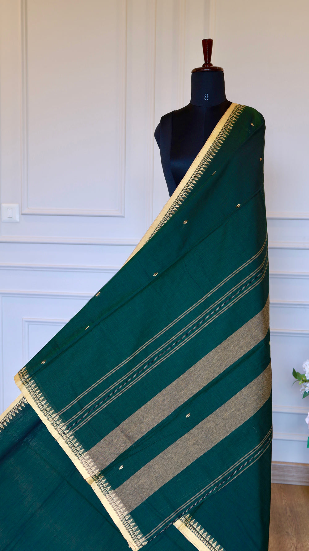 Detailed view of the Dhonekhali saree pallu featuring traditional golden thread stripes and temple border work