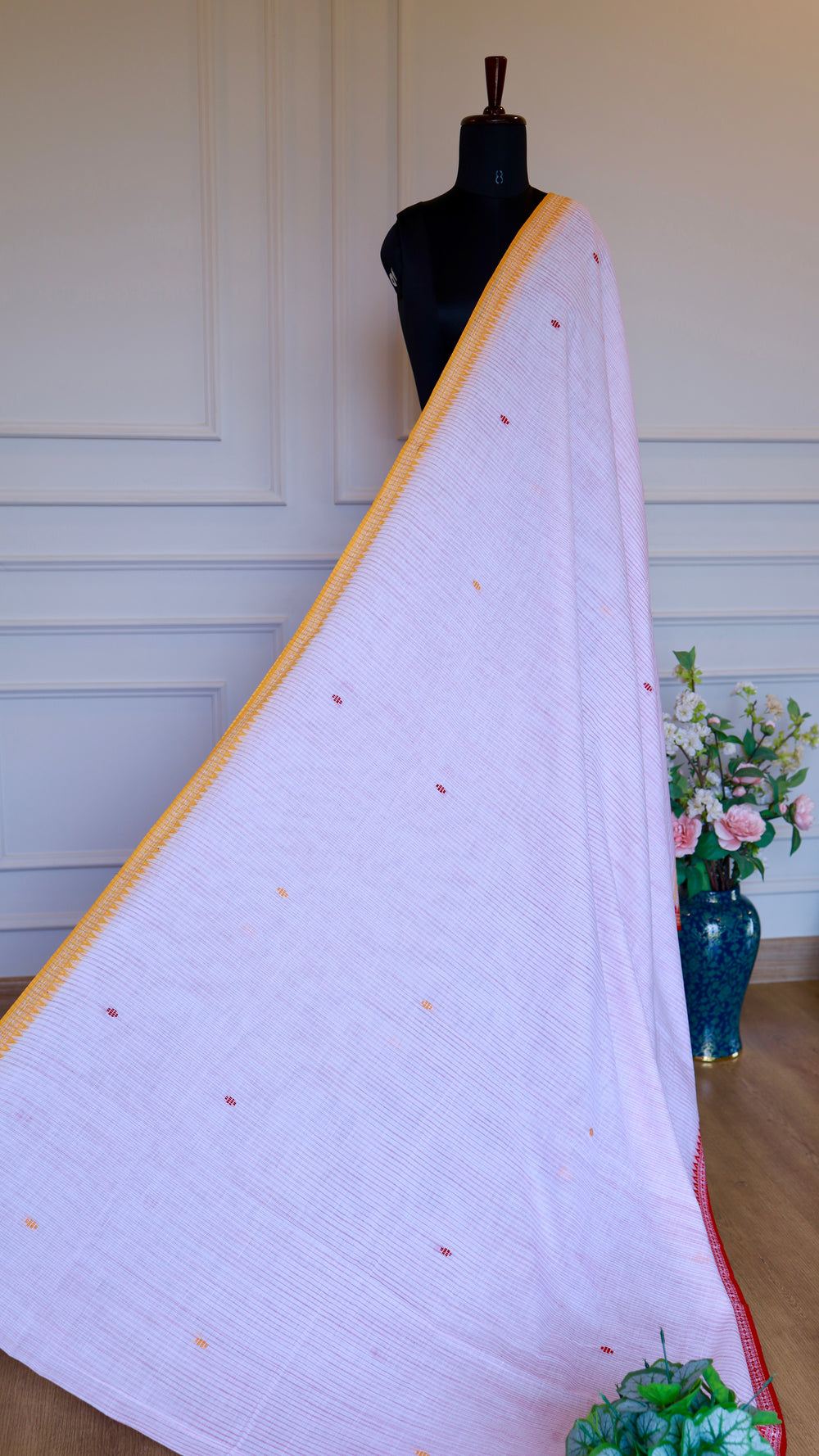 Traditional Dhonekhali handloom cotton saree displayed on a mannequin against a neutral background.
