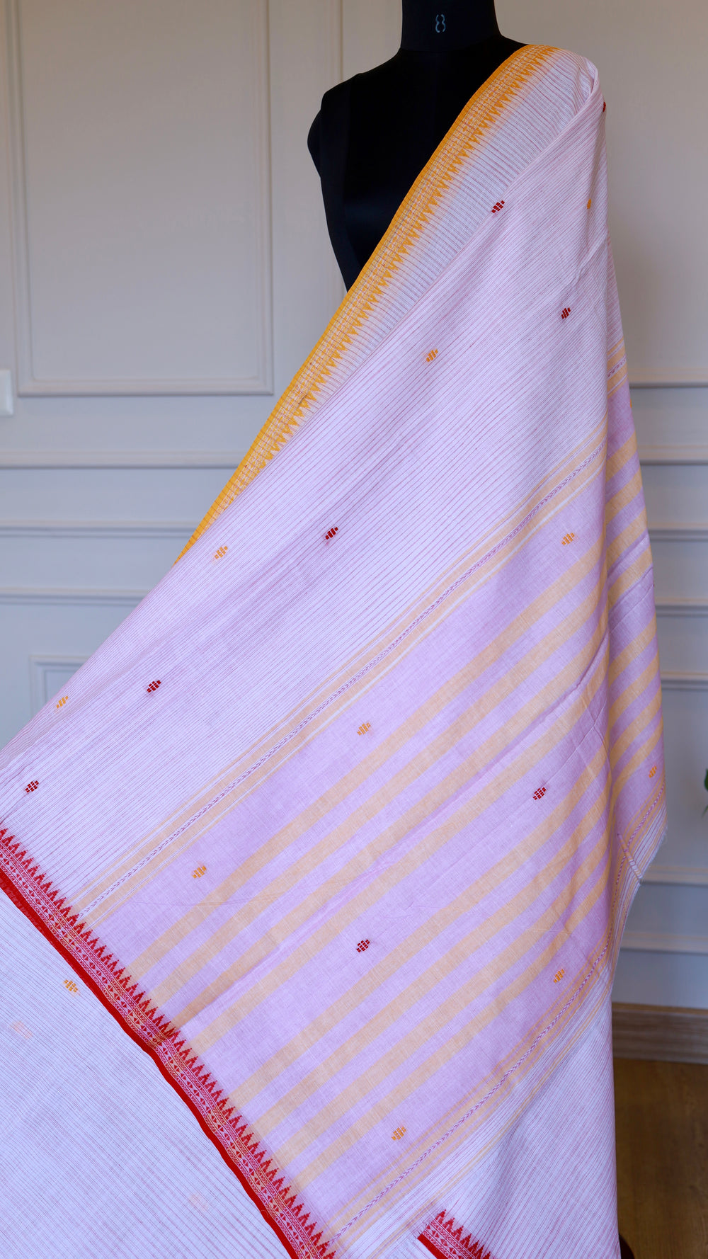 Full view of the Dhonekhali saree drape showing red and mustard horizontal stripes and thread work.