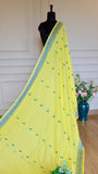 Full-length view of the lemon yellow Baluchari cotton saree showcased on a black mannequin, displaying the delicate blue floral butis and decorative border.