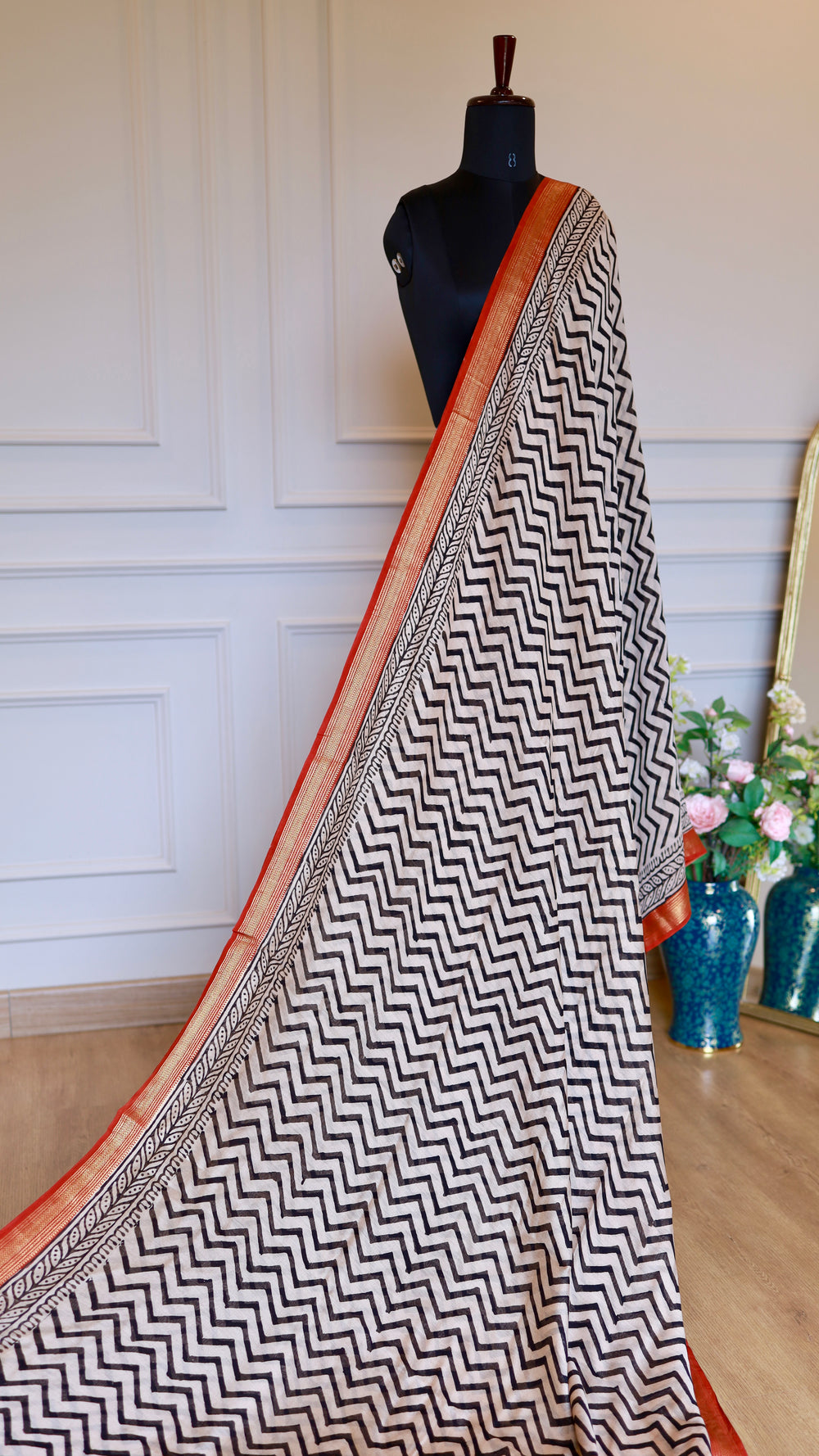 Front profile of the Handblock Printed Maheshwari Silk Saree displayed on a black boutique mannequin, demonstrating how the vertical chevron pattern elongates and flatters the silhouette.