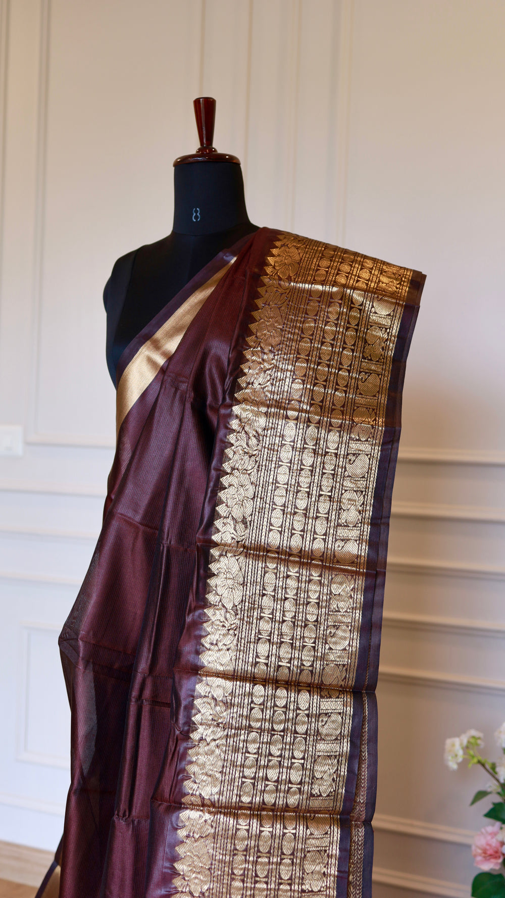 Upper torso drape shot showing the dark wine red Mangalagiri semi silk saree with broad golden zari border pleats
