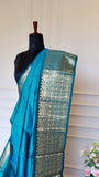 Detail shot of rich golden zari woven pallu design on Sky Blue Mangalagiri Saree.