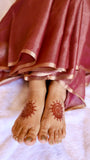 Mid-shot showcasing the handwoven silver zari leaf motifs on the pallu of the Rosewood Mauve Banarasi Saree.