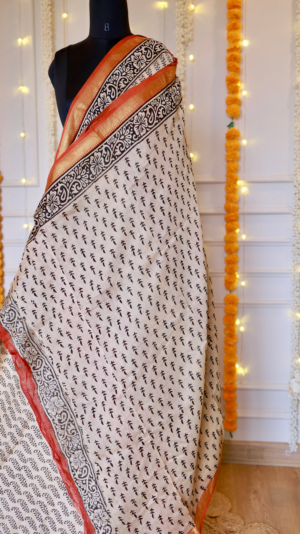 Detailed shot of leaf motif block printing and woven zari border on off-white Maheshwari silk saree