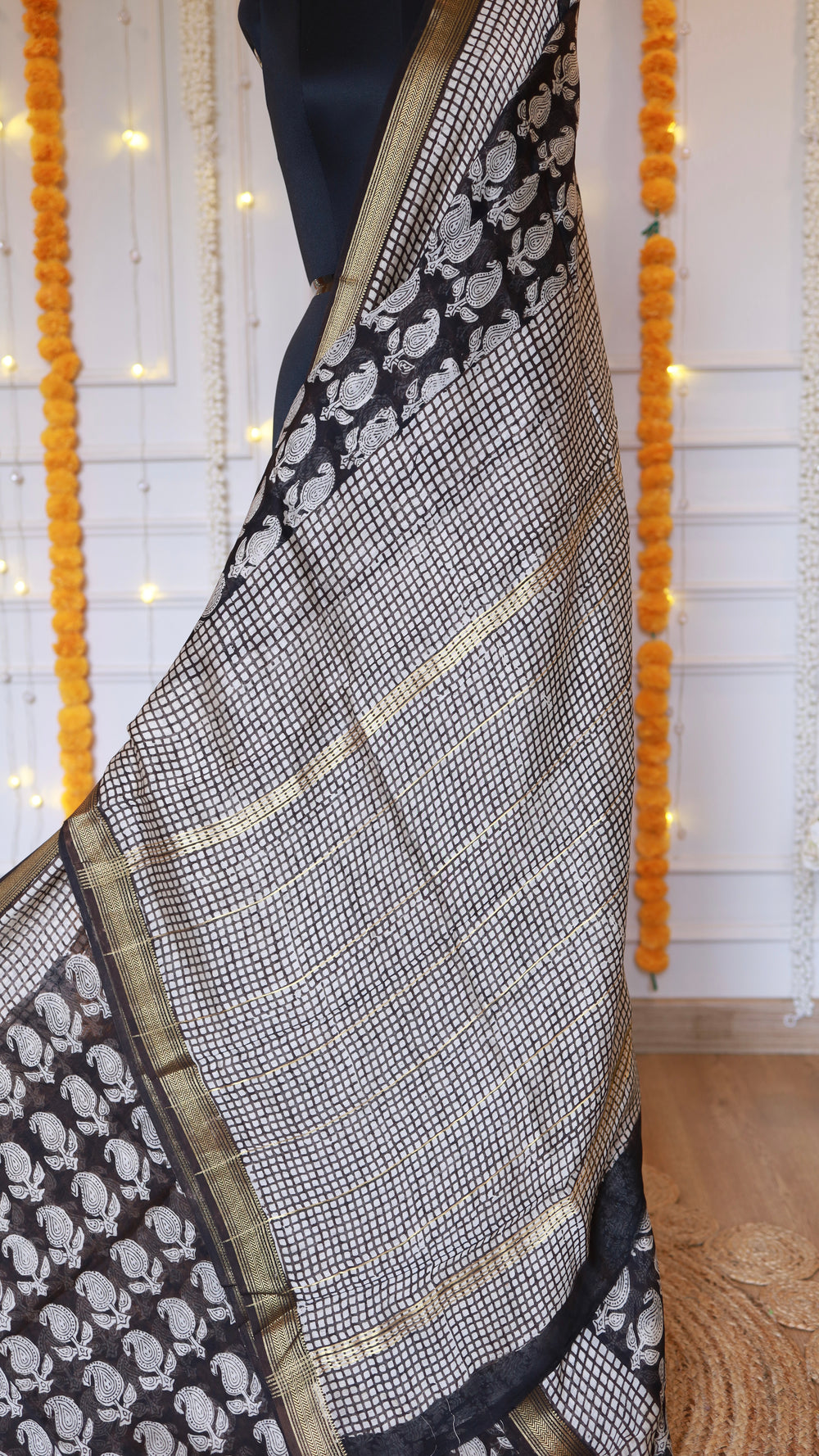 Detailed shot of checked zari grid pallu weave and block-printed sections on Black Maheshwari Silk Saree.