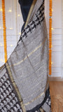 Detailed shot of checked zari grid pallu weave and block-printed sections on Black Maheshwari Silk Saree.