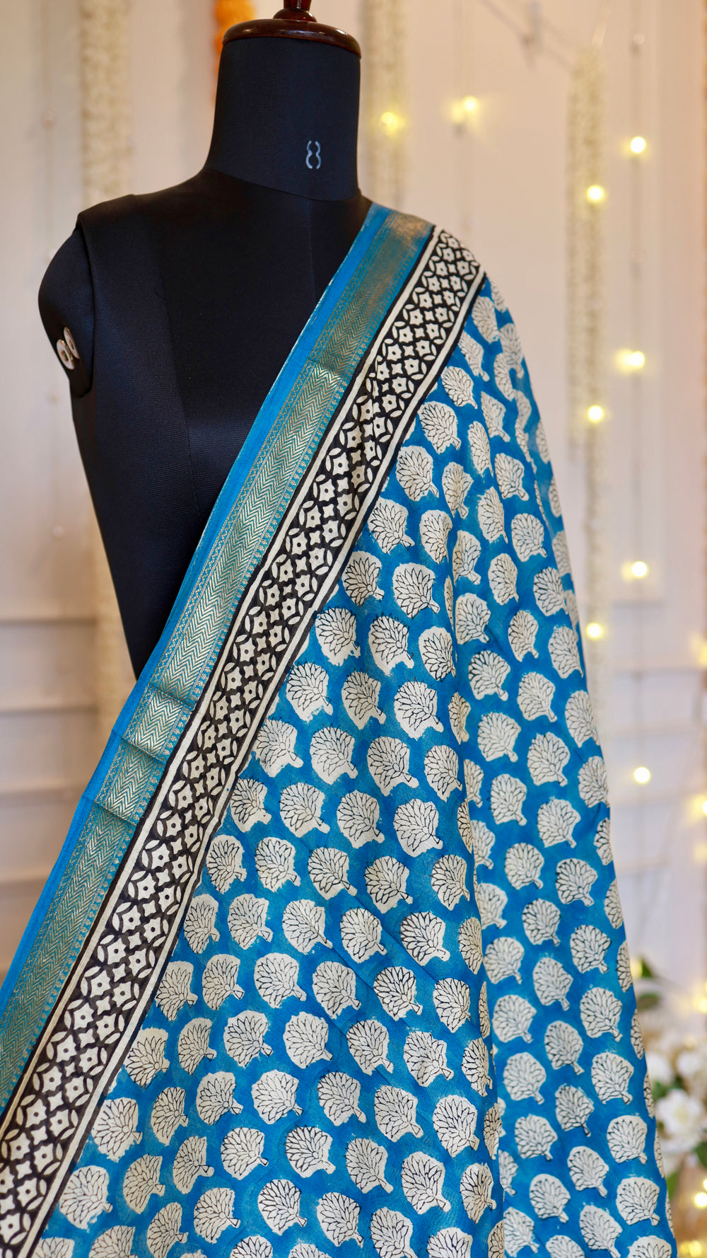 Upper drape angle of blue Maheshwari Silk Saree displaying the fine zari border weave and printed motifs.