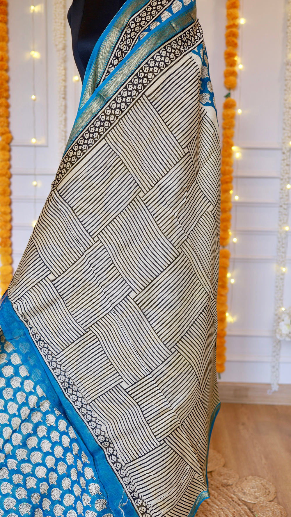 Maheshwari Silk Saree showcasing geometric cross-hatch block print pattern on off-white fabric with blue zari border