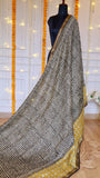 Full drape view of black and off-white diagonal stripe pattern on Maheshwari silk saree pallu with mustard accent border.