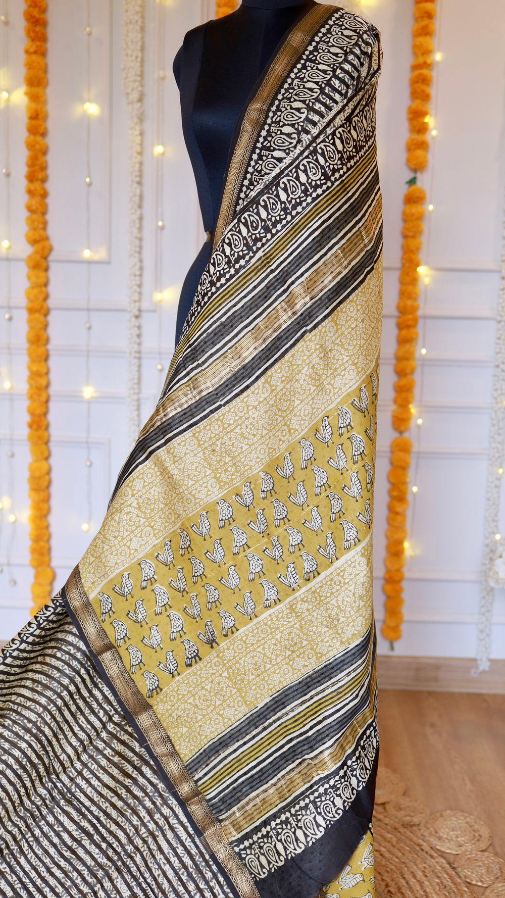 Detailed view of hand block printed bird and floral motifs framed by paisley zari border on Maheshwari silk saree pallu.
