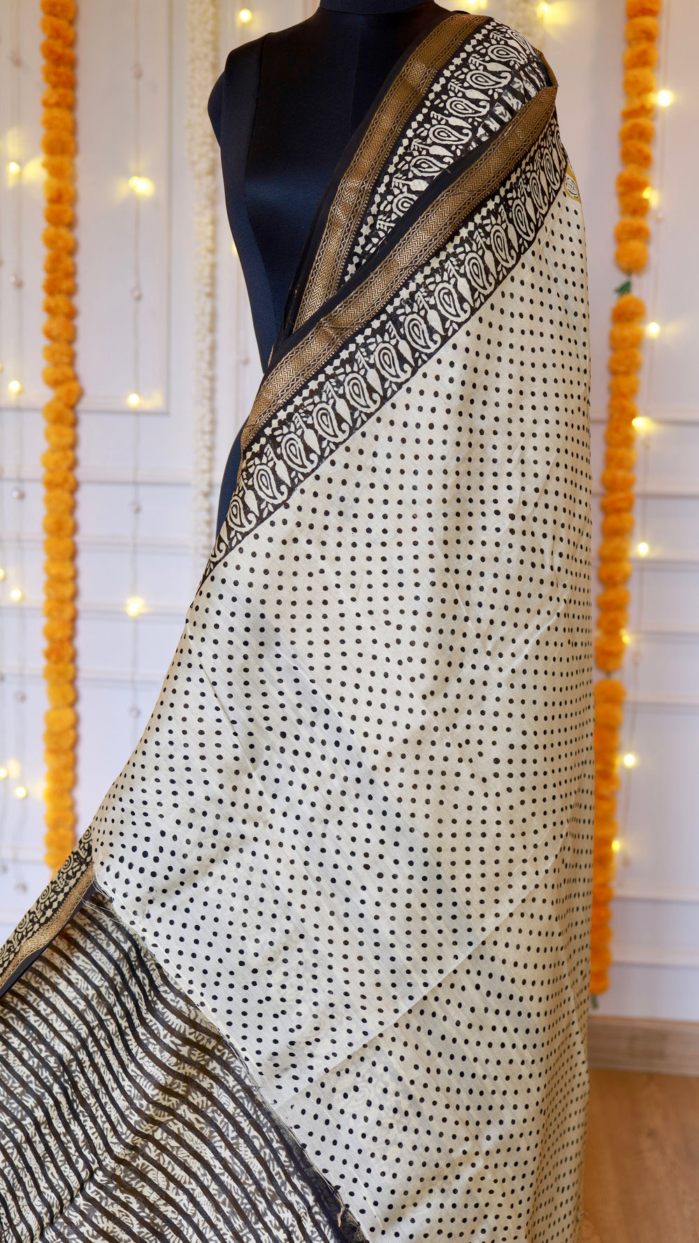 Off-white hand block printed section with small black polka dots on Maheshwari silk saree.