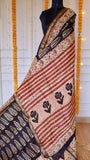 Detailed view of Maheshwari silk saree pallu showing rust-red diagonal stripes, block-printed rose motifs, and dark charcoal body fabric.