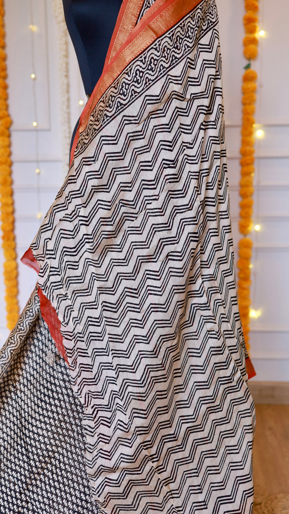Chevron and zigzag block print pattern details on cream and black Maheshwari silk saree pallu section
