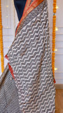 Chevron and zigzag block print pattern details on cream and black Maheshwari silk saree pallu section