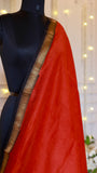 Close-up of Rust Red Maheshwari Silk Saree featuring a woven gold zari chevron border.