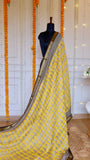 Full drape view of Yellow Maheshwari Silk Saree with paisley motifs and black grid border styled on a mannequin.