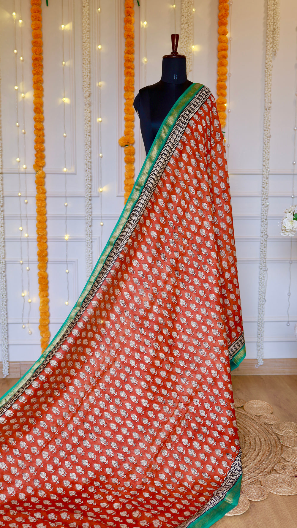 Full length view of Rust Red Maheshwari Silk Saree draped elegantly with all-over traditional block prints.
