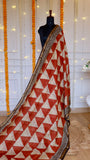 Rust orange and beige geometric triangle printed Maheshwari silk saree draped on mannequin