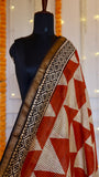 Close-up view of rust orange striped triangle pattern with woven zari border on Maheshwari silk saree